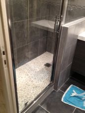 Une douche avec des jolis galets blancs